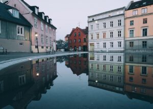 Damstredets bygninger som reflekteres i vannet, fotokunst veggbilde / plakat av Tor Arne Hotvedt